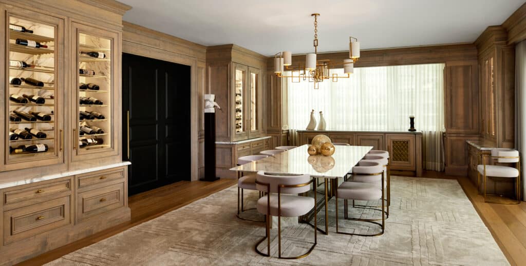 Sophisticated dining room with marble-top table, built-in wine storage, and modern brass lighting
