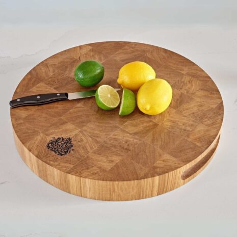 circular-chopping-board (1) A circular chopping board with fruit and a knife on top of it