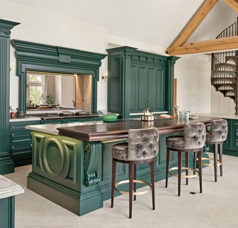Traditional Hampshire kitchen with deep green cabinetry, ornate island detailing, and exposed oak ceiling beams